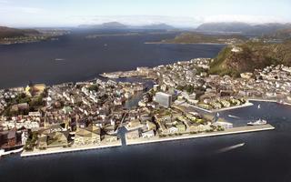 Interpretation of a possible future in Ålesund. The picture is a visualistion from above of how the Sørsida area might look in the future. It show the city of Ålesund and what appears to be a seriies of new buildings on the waterfront area.