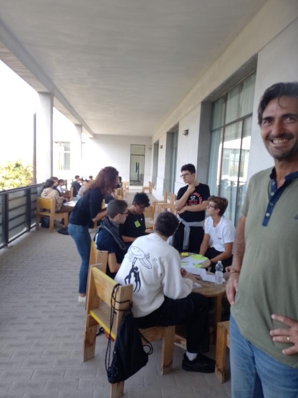 Students working in groups on a large balcony